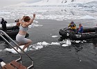Porcquoi Pas Island and Polar Plunge  The Polar Plunge.  Caroline taking a flying leap into water.  Notice the brash ice in the water.  It might be cold?
